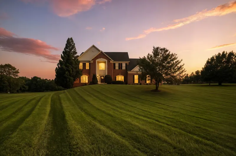 Brick colonial at twilight on a large lawn in Leesburg, VA